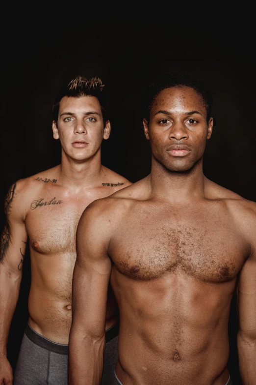 a group of men standing next to each other, by Zack Stella, beautiful gemini twins portrait, sports illustrated, chest and face, alana fletcher