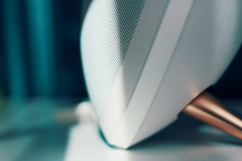 a close up of a speaker on a table, trending on pexels, wearing white clothes, smooth oval head, close up to the screen, smooth light shading