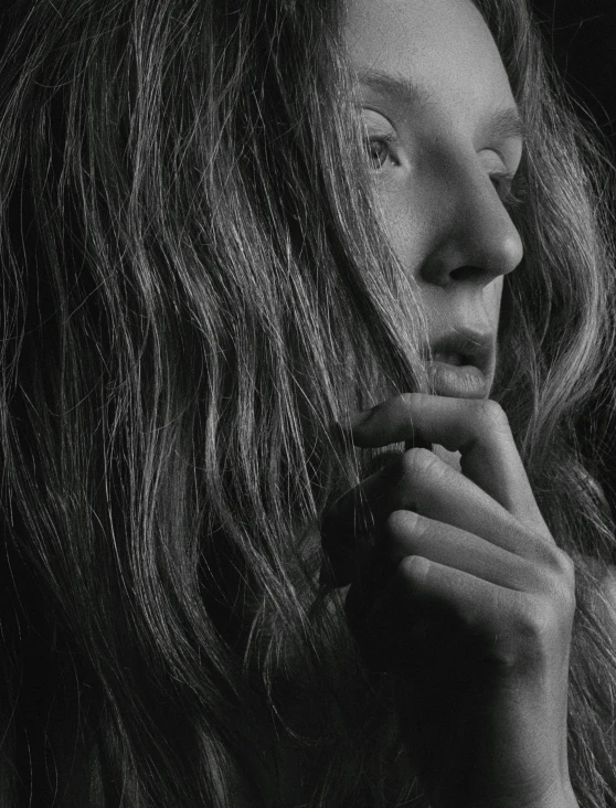 a black and white photo of a woman with long hair, by andrei riabovitchev, unsplash, hyperrealism, robert plant, hand on cheek, alternate album cover, thoughtful )