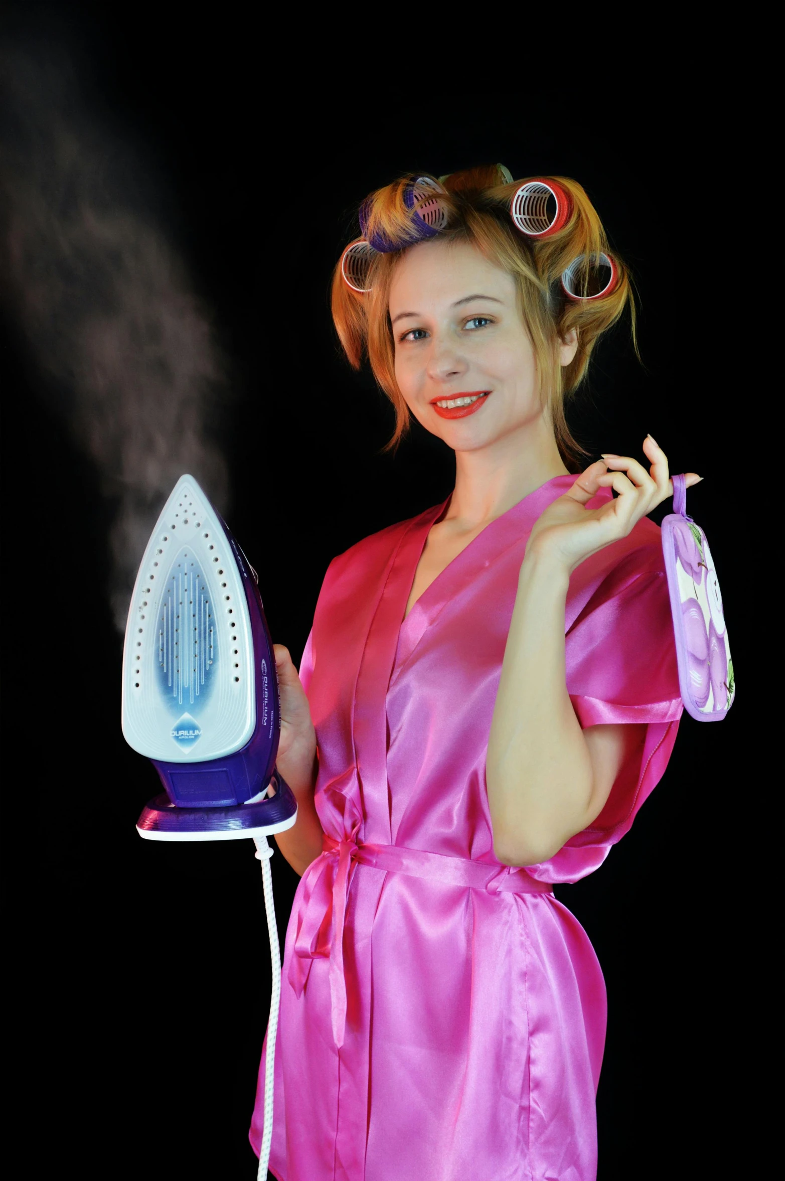 a woman in a pink robe holding an iron, inspired by Godfried Schalcken, pixabay contest winner, hairspray, smoke and gas, with a long, young beautiful amouranth