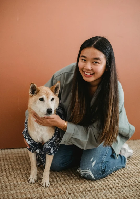 a woman sitting on the floor with a dog, trending on unsplash, shin hanga, wearing a cute top, portrait of a japanese teen, brown, plain background