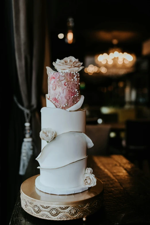 a wedding cake sitting on top of a table, by Robbie Trevino, unsplash, art nouveau, instagram story, glittering and soft, beautifully soft lit, modelling