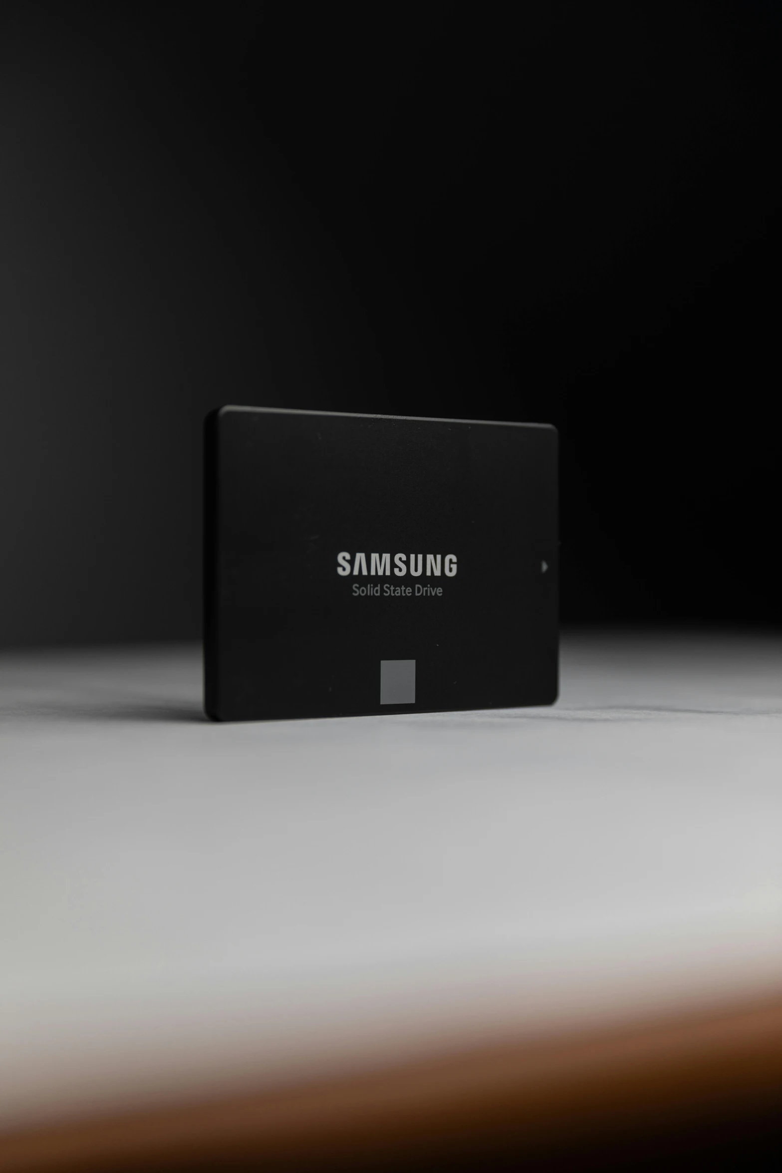 a close up of a hard drive on a table, hyperdetailed samsung store, promo image, all black matte product, low iso