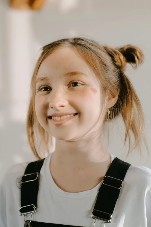 a young girl in a white shirt and black overalls, a character portrait, trending on pexels, pigtail, smiling, cleft chin, teenage girl