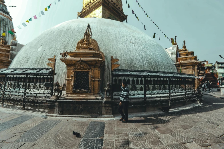 a large white dome sitting in the middle of a street, unsplash contest winner, nepal, a person standing in front of a, giant tomb structures, panoramic