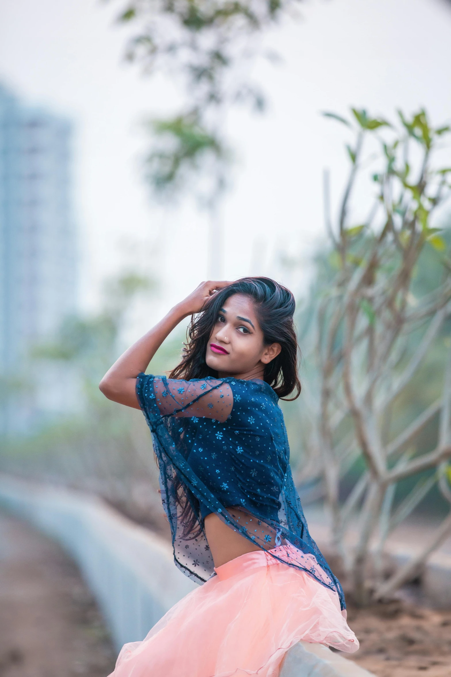 a woman sitting on top of a cement wall, by Max Dauthendey, girl graceful, low quality photograph, 15081959 21121991 01012000 4k, wearing crop top