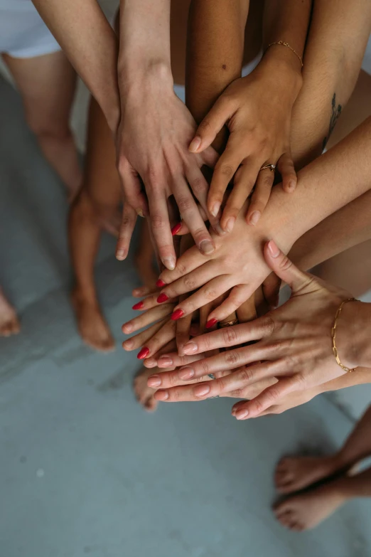 a group of people putting their hands together, by Nina Hamnett, ballet, square, 15081959 21121991 01012000 4k, high angle