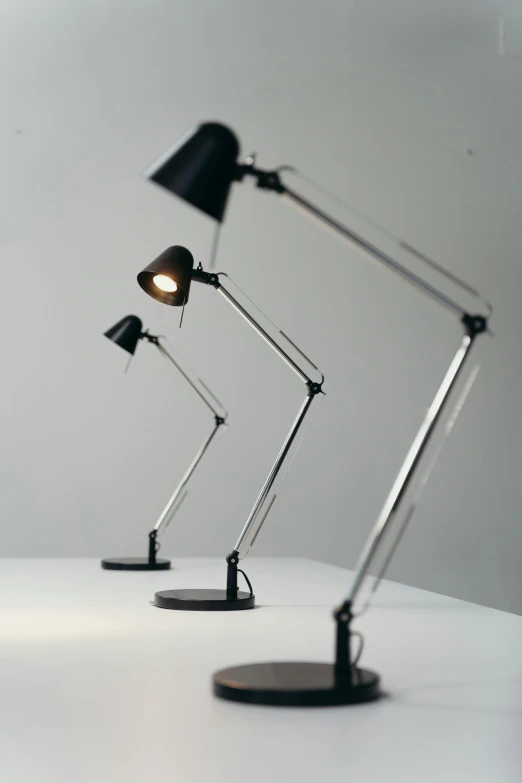 a couple of lamps sitting on top of a table, inspired by Constantin Hansen, unsplash, hyperrealism, fully posable, articulated joints, cinematic counter light, strong spotlights