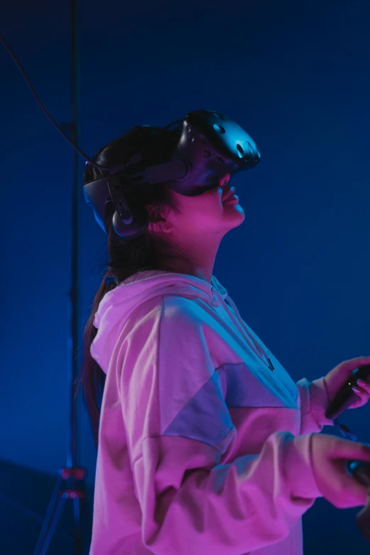 a couple of people standing next to each other on a stage, a hologram, inspired by Jules Chéret, unsplash, interactive art, wearing gaming headset, as she looks up at the ceiling, indigo, close up portrait shot