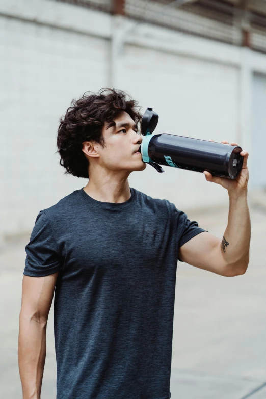a young man drinking from a water bottle, inspired by John Luke, pexels contest winner, carrying two barbells, lean man with light tan skin, black, teal energy