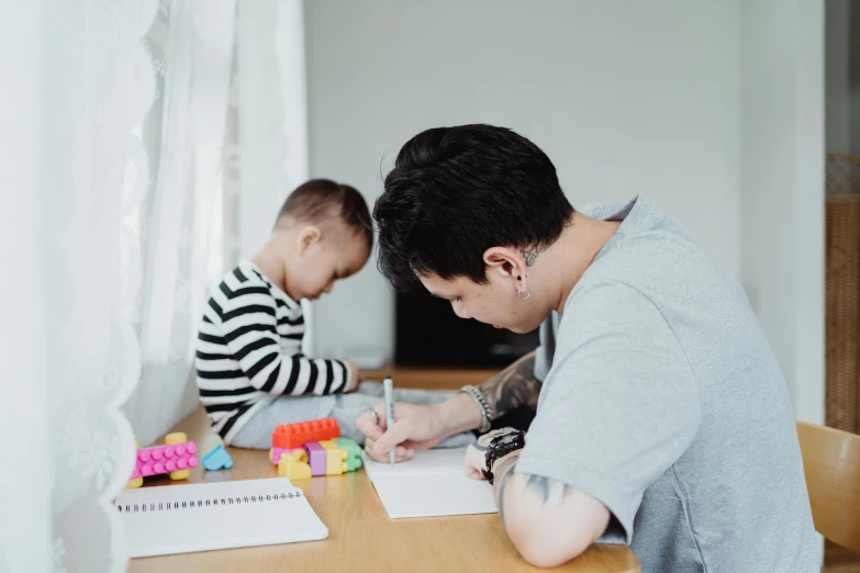 a woman sitting at a table with a child, a child's drawing, by Joseph Severn, pexels contest winner, asian man, father with child, te pae, slightly minimal