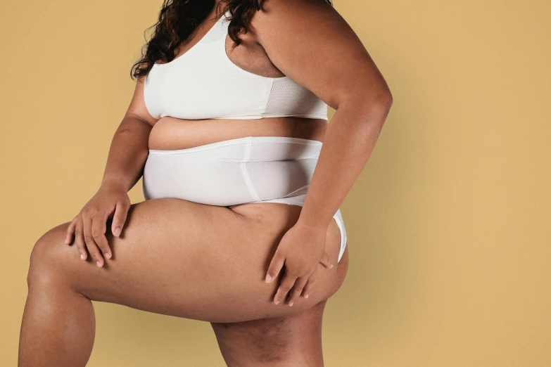 a woman in a white underwear posing for a picture, by Carey Morris, trending on pexels, morbidly obese, tan skin, editorial image, bloated