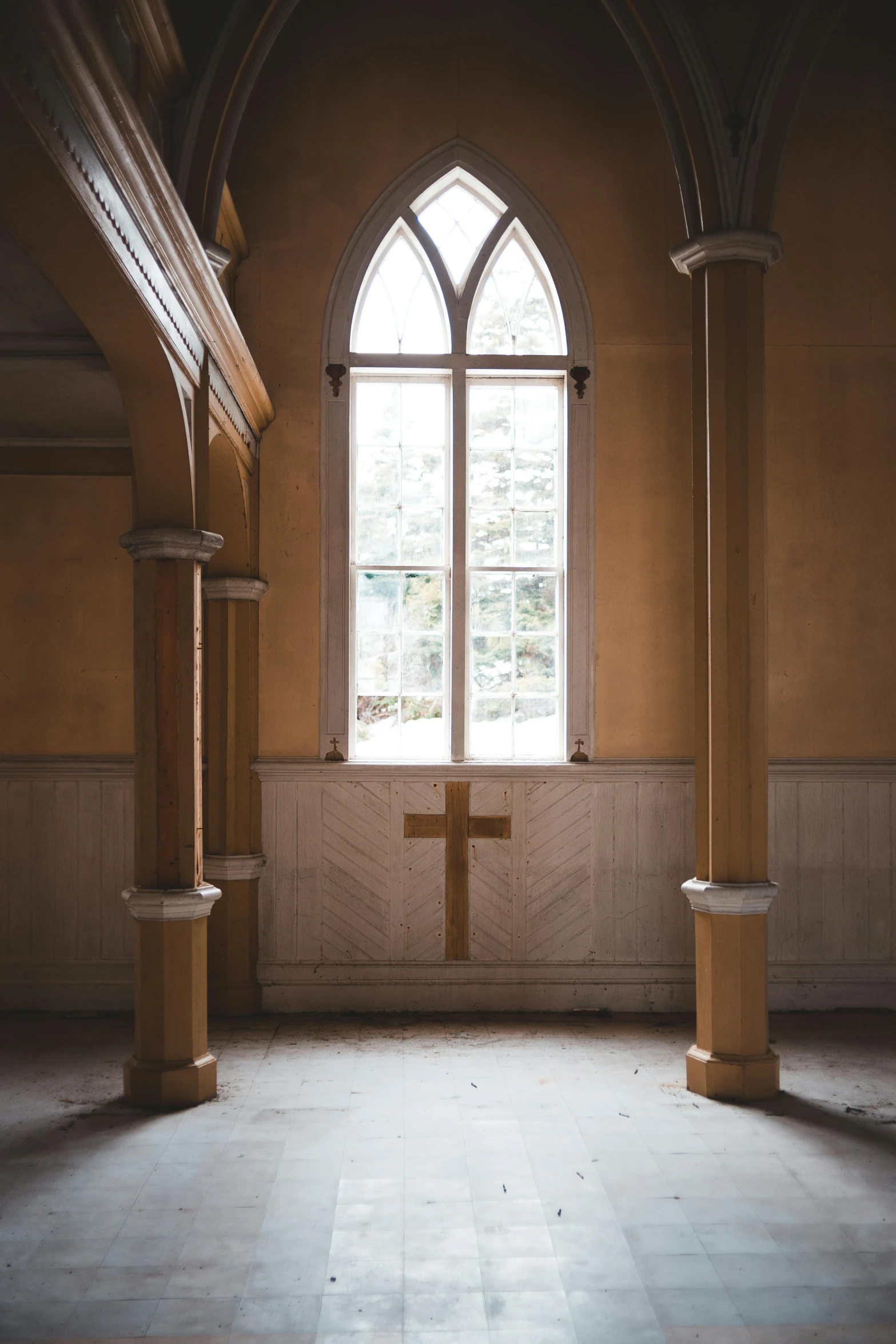 an empty room with a window and a cross on the wall, unsplash, renaissance, pillars, brown, dressed in a worn, gothic revival