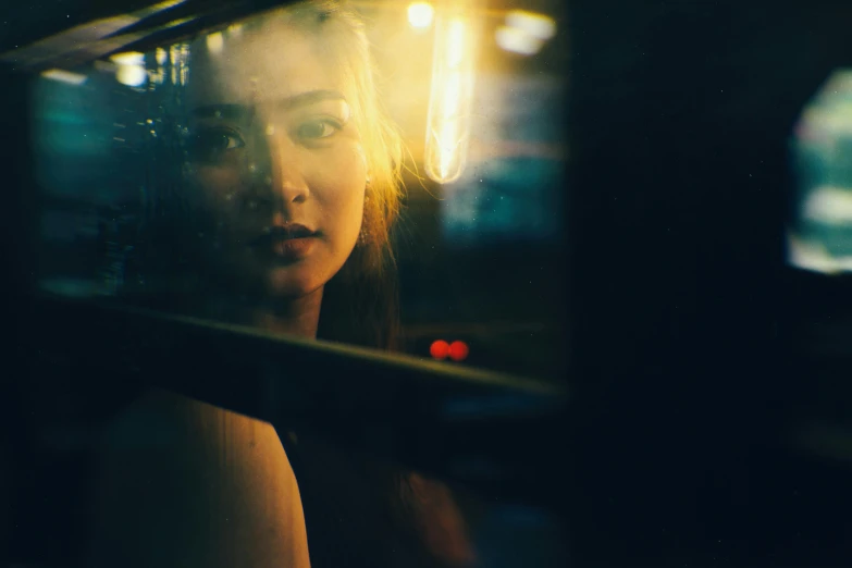 a woman looking out the window of a bus, inspired by Elsa Bleda, pexels contest winner, photorealism, yellow lights, girl under lantern, side portrait of imogen poots, an asian woman
