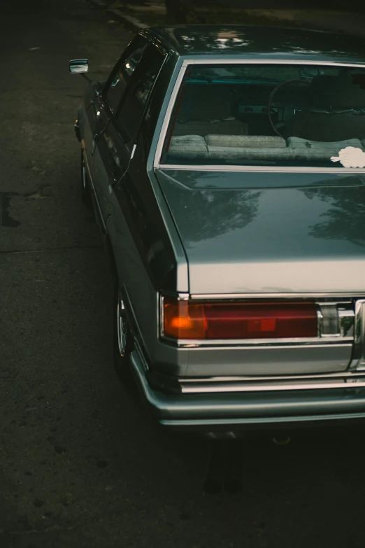 a car parked on the side of the road, an album cover, inspired by Elsa Bleda, pexels contest winner, grey metal body, lowrider style, tail lights, ignant