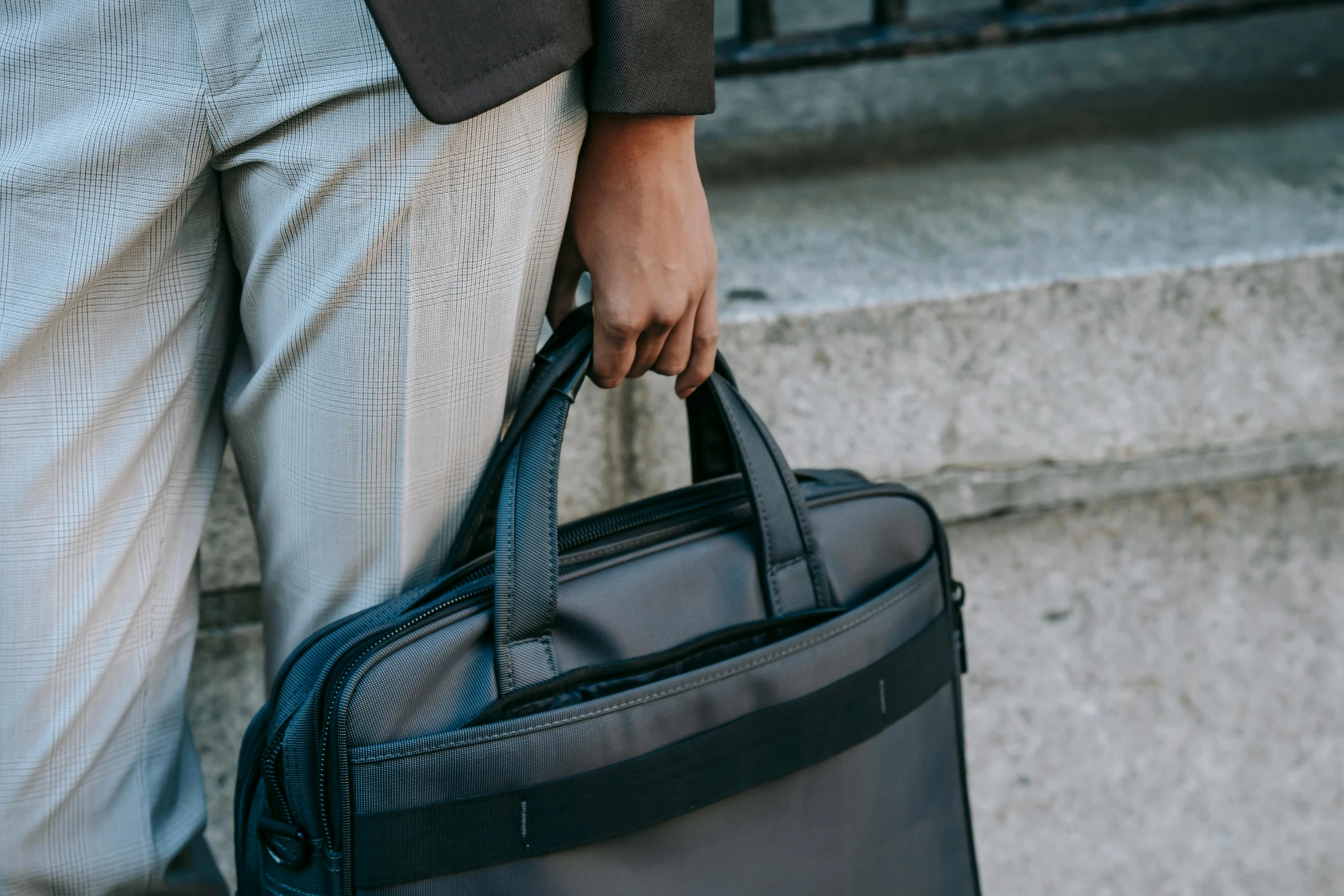 a close up of a person holding a briefcase, by Carey Morris, pexels contest winner, in gunmetal grey, high-body detail, ergonomic, well-appointed space