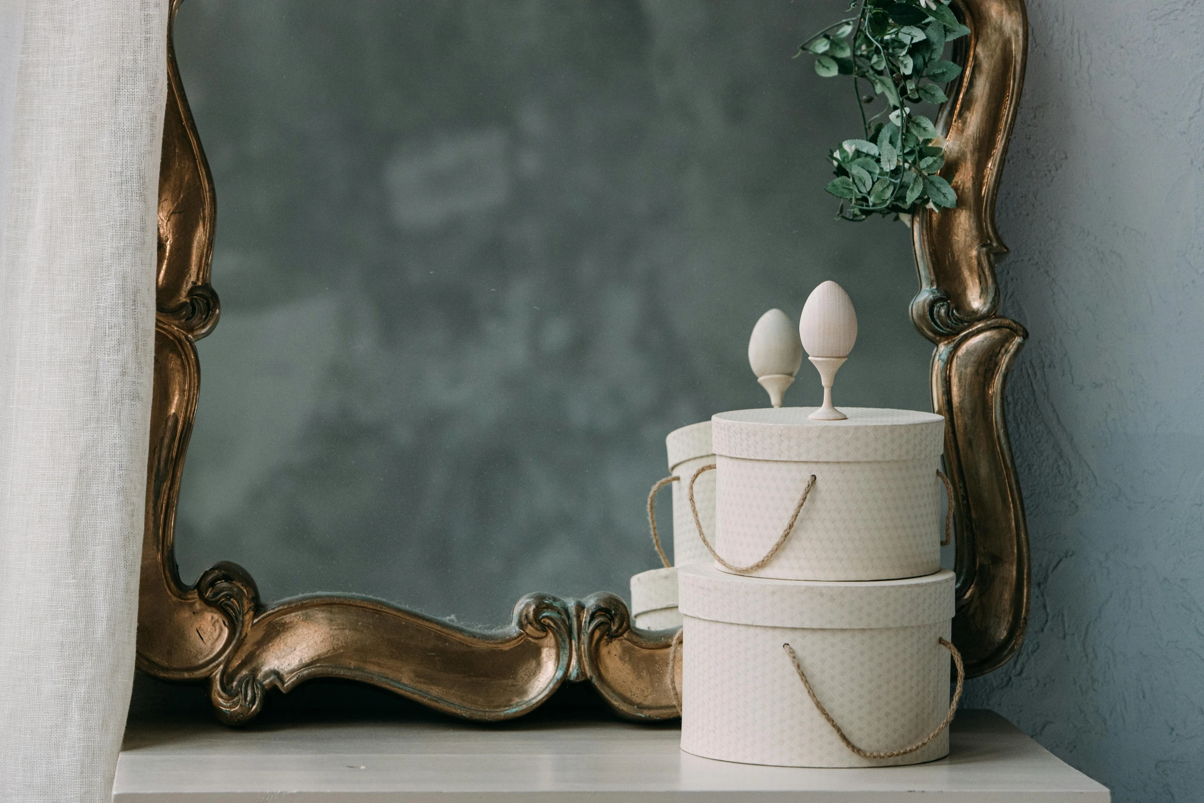 a white cake sitting on top of a table next to a mirror, inspired by Eden Box, unsplash, rococo, two organic looking towers, with an easter basket, polka dot tables, elegantly posing over you