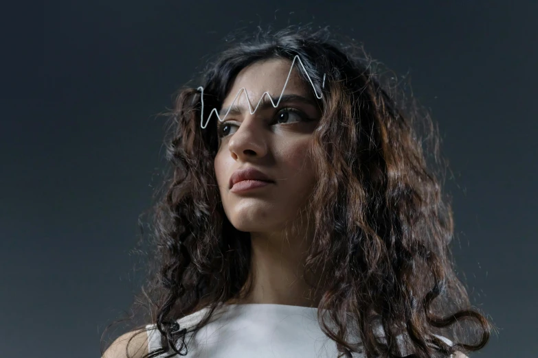 a woman in a white dress posing for a picture, an album cover, trending on pexels, featuring rhodium wires, young middle eastern woman, brain interface, magnetic waves