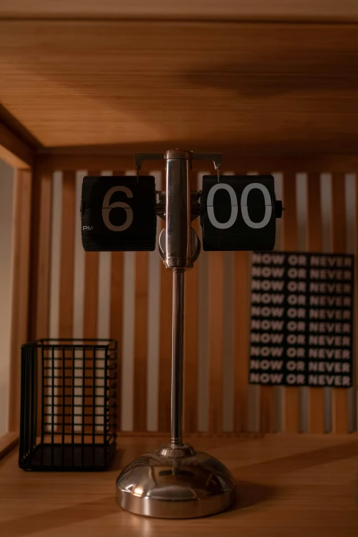 a clock sitting on top of a wooden table, set at night