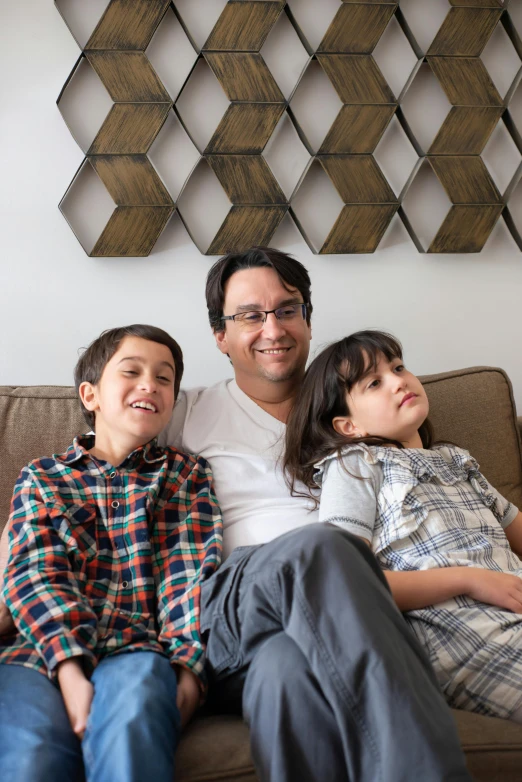 a man and two boys sitting on a couch, featured on reddit, altermodern, fan favorite, from wheaton illinois, profile image, looking towards camera