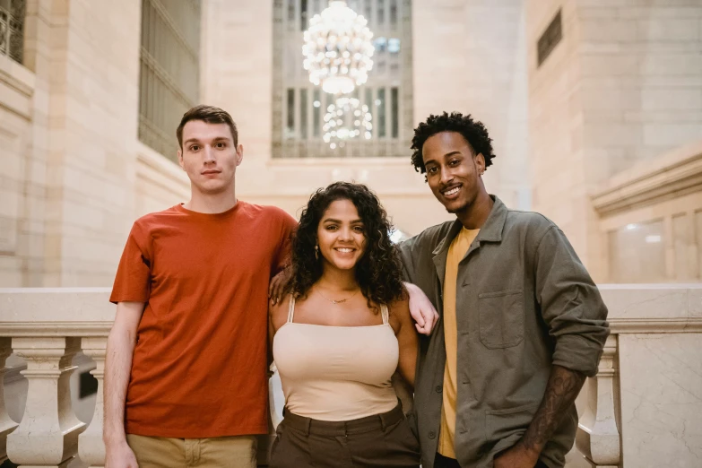 a group of three people standing next to each other, pexels contest winner, light skin tone, humans of new york, college students, indoor picture