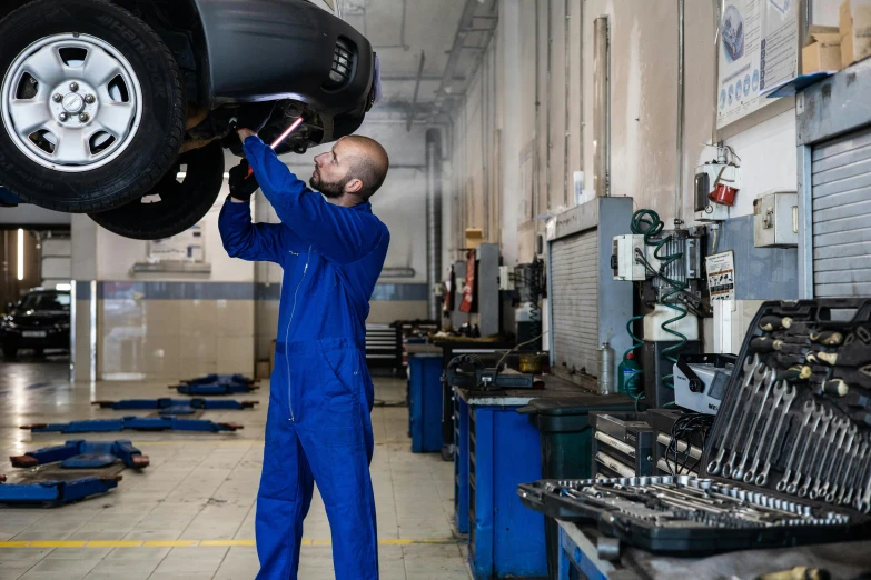 a mechanic working on a car in a garage, pexels contest winner, renaissance, avatar image, caucasian, medium height, decorative