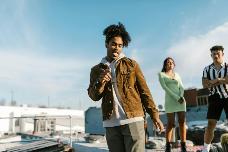 a group of people standing on top of a roof, an album cover, trending on pexels, happening, black teenage boy, performing a music video, looking to his side, medium shot of two characters