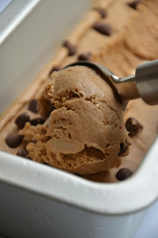 a scoop of chocolate chip ice cream in a pan, by Robbie Trevino, journalism photo, rectangular, 1 2 9 7, order