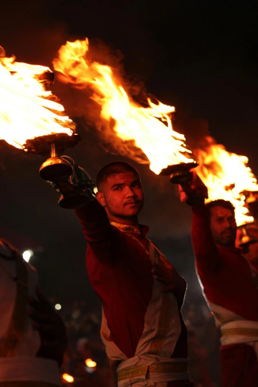 a group of men standing next to each other holding torches, hindu aesthetic, in 2 0 1 5, red flames, turkey