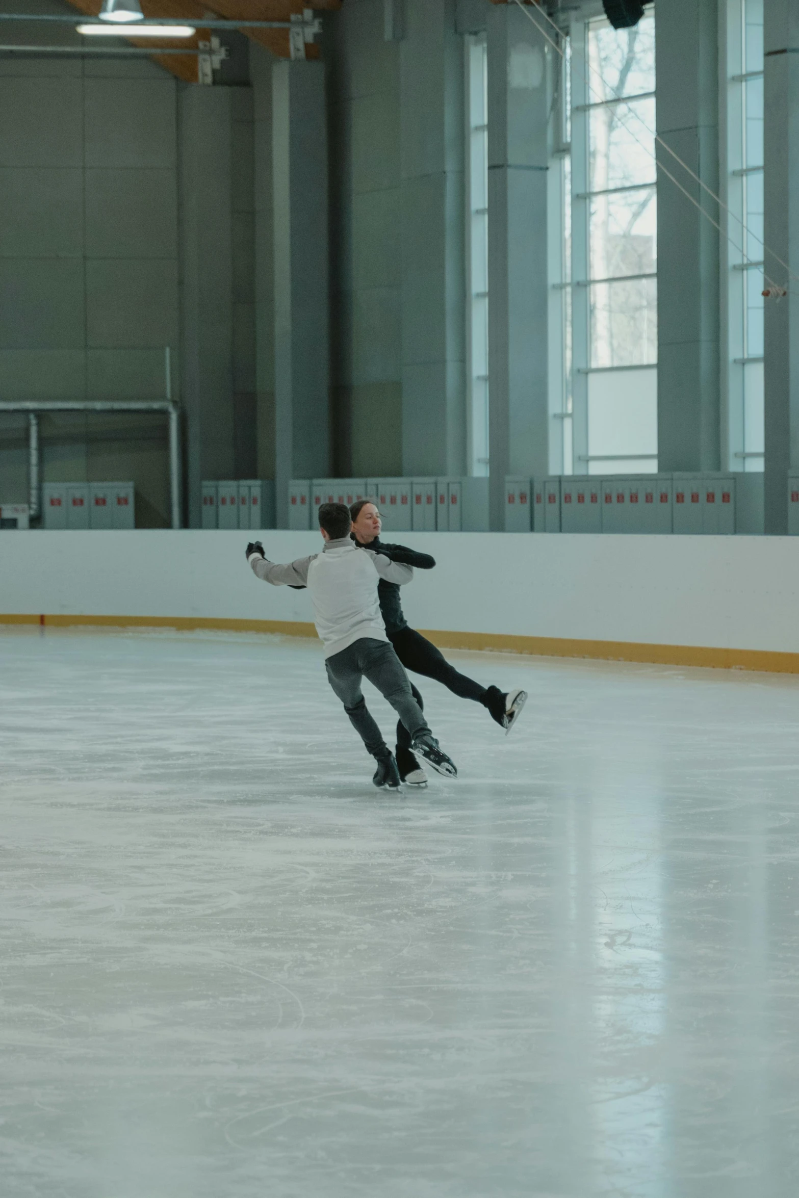 a man riding a skateboard on top of an ice rink, arabesque, couple dancing, dasha taran, still frame, fujifilm”