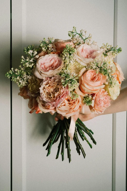 a close up of a person holding a bouquet of flowers, a pastel, inspired by François Boquet, featured on instagram, romanticism, in shades of peach, intricate details. front on, natural point rose', unimaginably huge