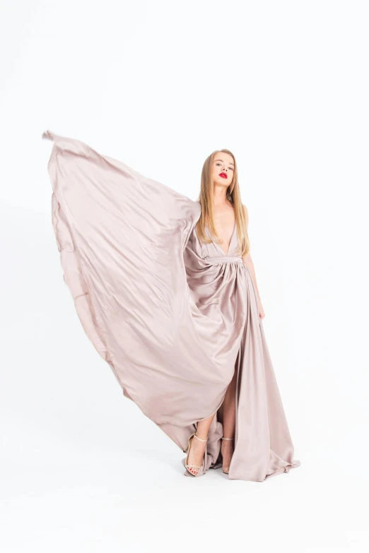 a woman in a long dress on a white background, an album cover, by Gavin Hamilton, unsplash, 15081959 21121991 01012000 4k, taupe, flowing pink-colored silk, full height