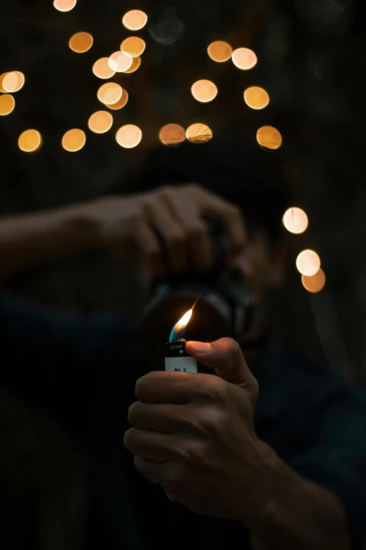 a person holding a lighter in their hand, pexels contest winner, natural candle lighting, profile picture, muted lights, instagram photo