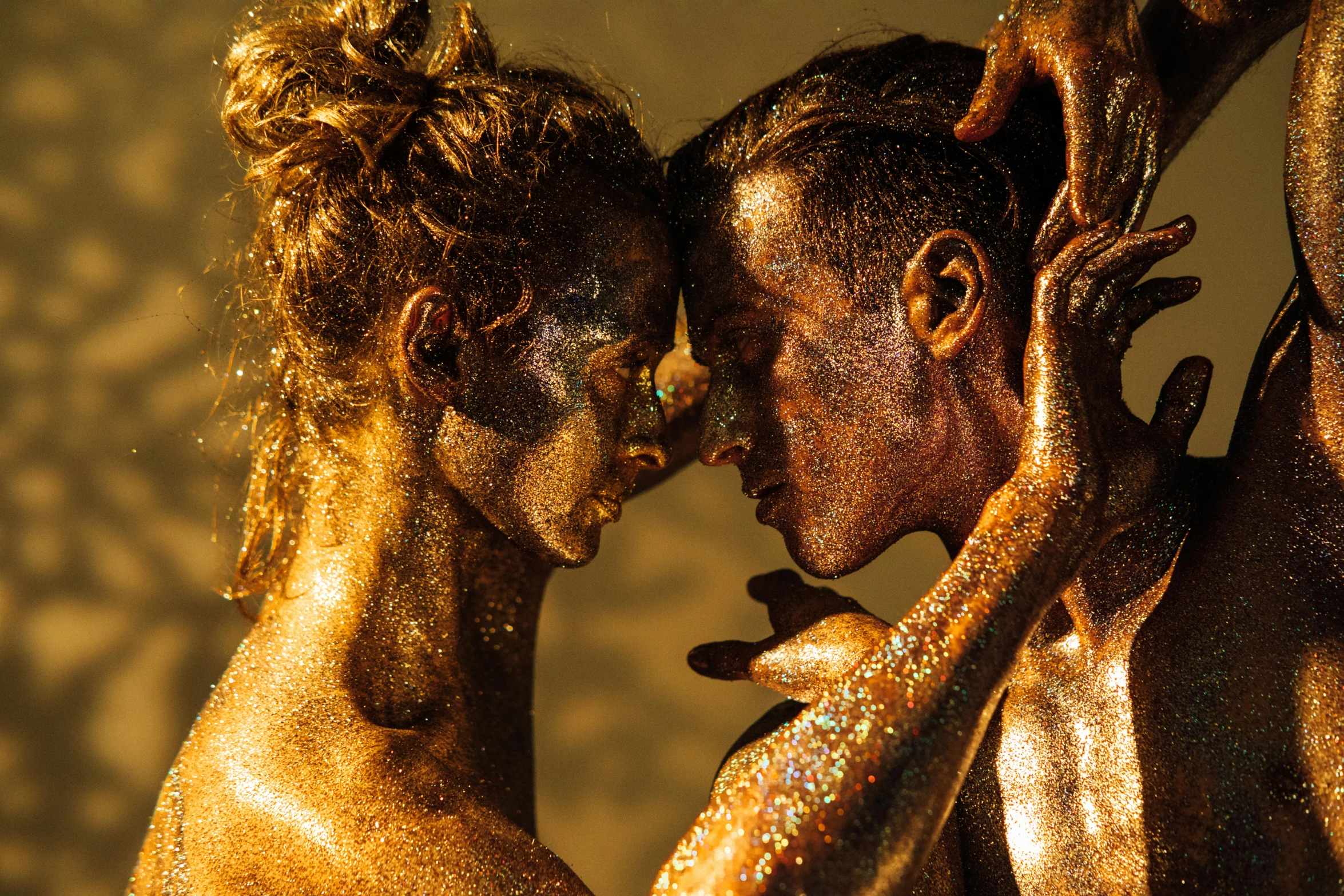 a man and a woman covered in gold paint, by Daniel Lieske, pexels contest winner, gold dappled light, sweaty 4 k, thumbnail, full of sand and glitter