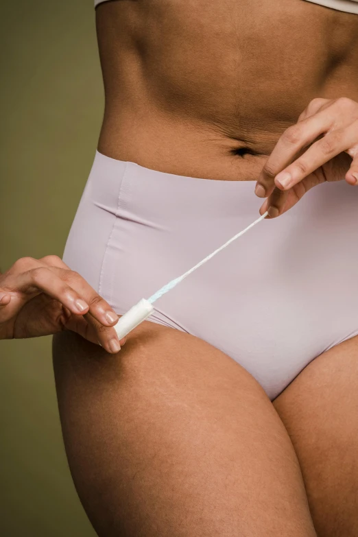 a close up of a person in a bikini holding a toothbrush, dribble, membrane pregnancy sac, silky garment, exposed thighs, sterile colours
