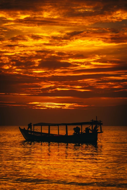 a boat floating on top of a body of water, by Peter Churcher, pexels contest winner, romanticism, sunsetting color, cambodia, nat geo, jamaica