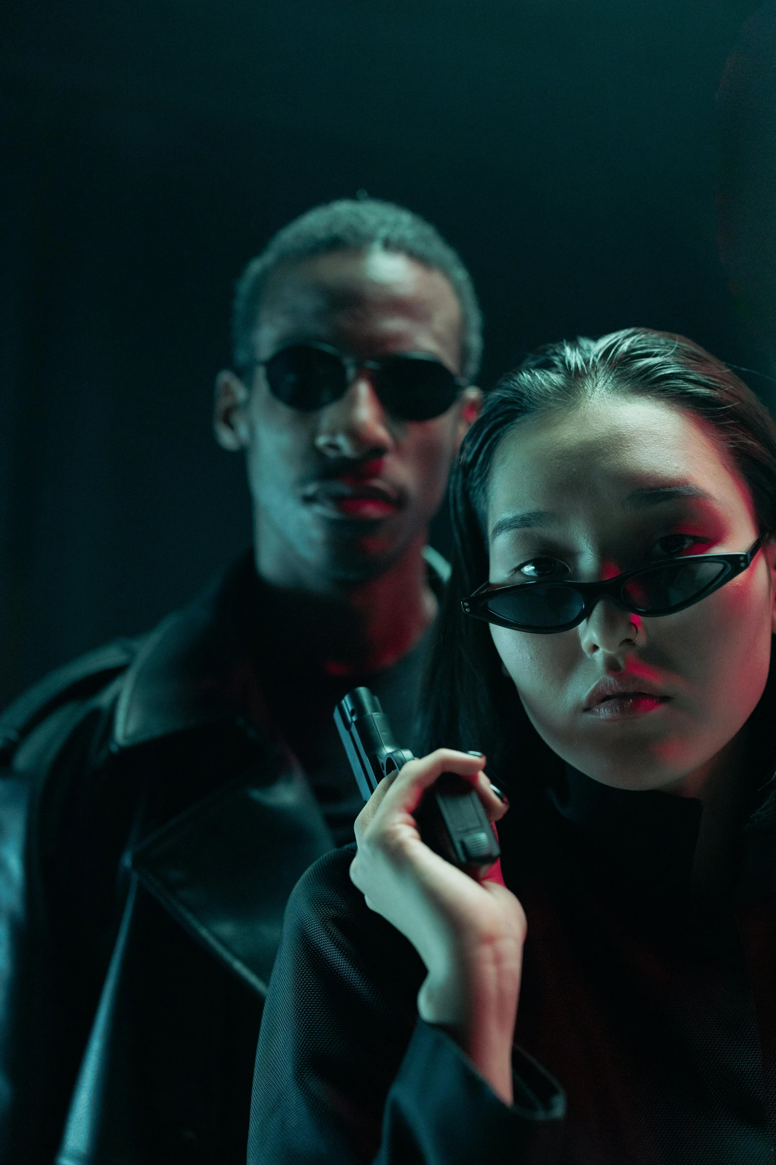 a couple of people standing next to each other, an album cover, inspired by Zhu Da, trending on pexels, cyberpunk sunglasses, cop, bodycam, movie action still frame