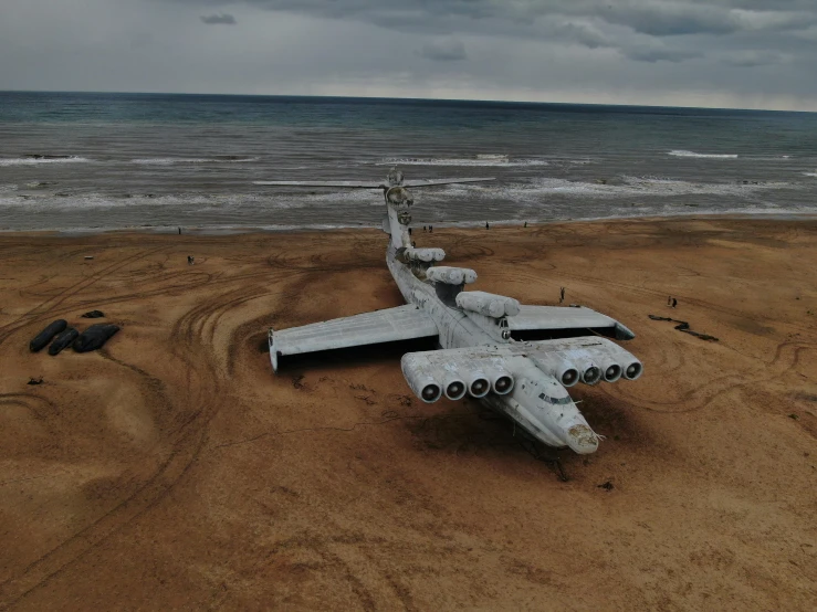 a plane sitting on top of a sandy beach, inspired by Filip Hodas, pexels contest winner, surrealism, soviet yard, panels, military drone, vostok-1