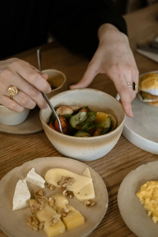 a person sitting at a table with plates of food, a still life, inspired by Constantin Hansen, unsplash, bowl, detail shot, cast, carefully crafted