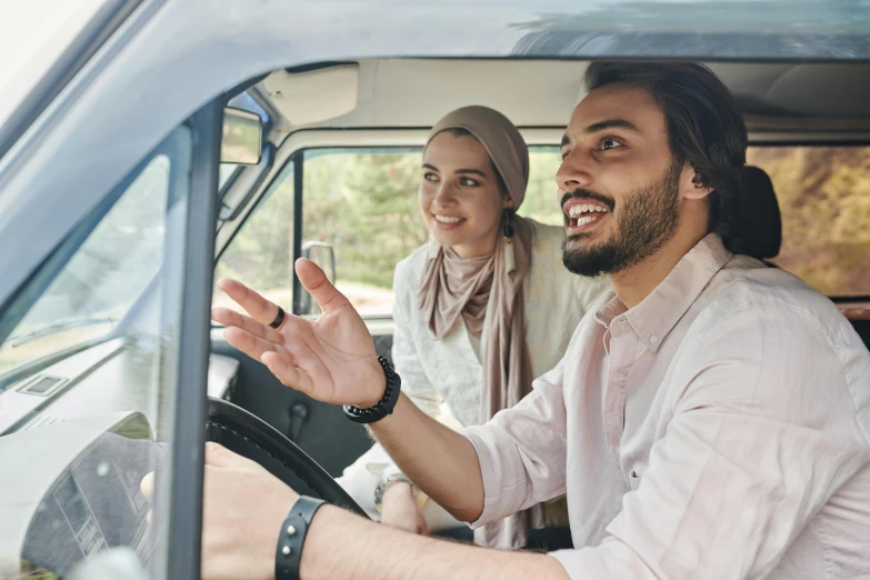 a man and a woman sitting in the driver's seat of a car, hurufiyya, profile image