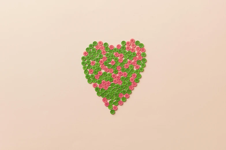 a green and pink heart on a pink background, by Emma Andijewska, trending on pexels, generative art, pressed penny art, made of lollypops, beads, wedding