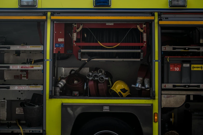 a yellow fire truck parked in a garage, by Derek Chittock, pexels, avatar image, patterned, helmet view, panoramic shot