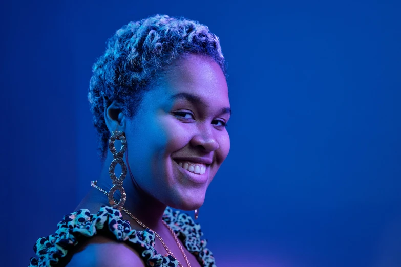 a close up of a person smiling at the camera, an album cover, pexels contest winner, nettie wakefield, glowing blue, mixed race, youtube thumbnail