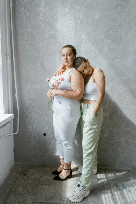 a couple of women standing next to each other, inspired by Elsa Bleda, trending on pexels, renaissance, in white room, plus size, white pants, yulia nevskaya