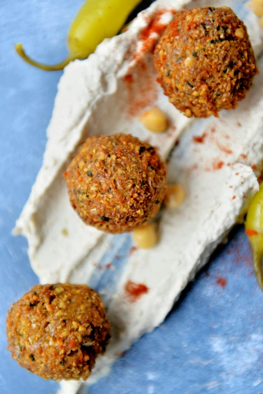 a close up of a plate of food on a table, dau-al-set, cannonballs, profile image, thumbnail, middle eastern details