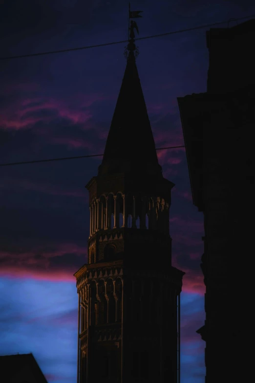 a tall tower with a clock on top of it, a picture, by Agnolo Gaddi, pexels contest winner, romanesque, venice at dusk, purple and red, obscured underexposed view, after the storm