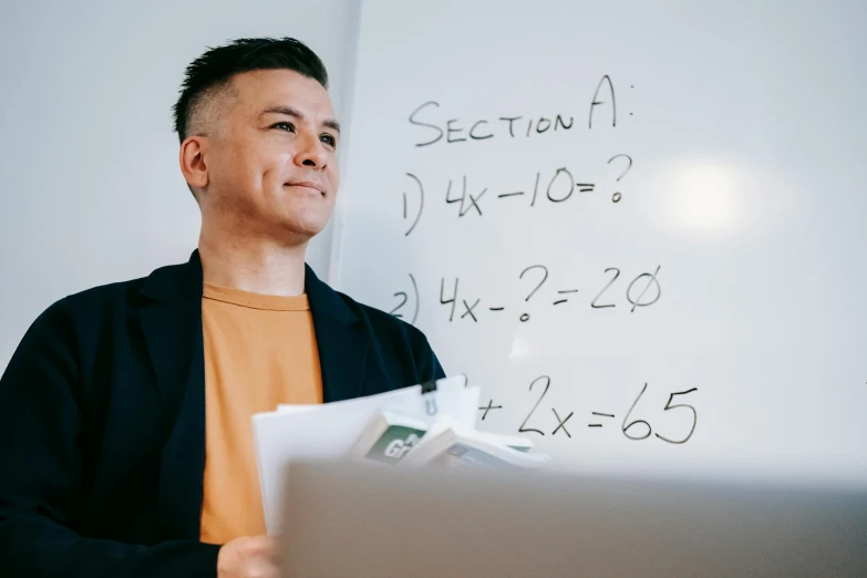 a man standing in front of a laptop computer, pexels contest winner, math inspired, whiteboards, darren quach, lachlan bailey