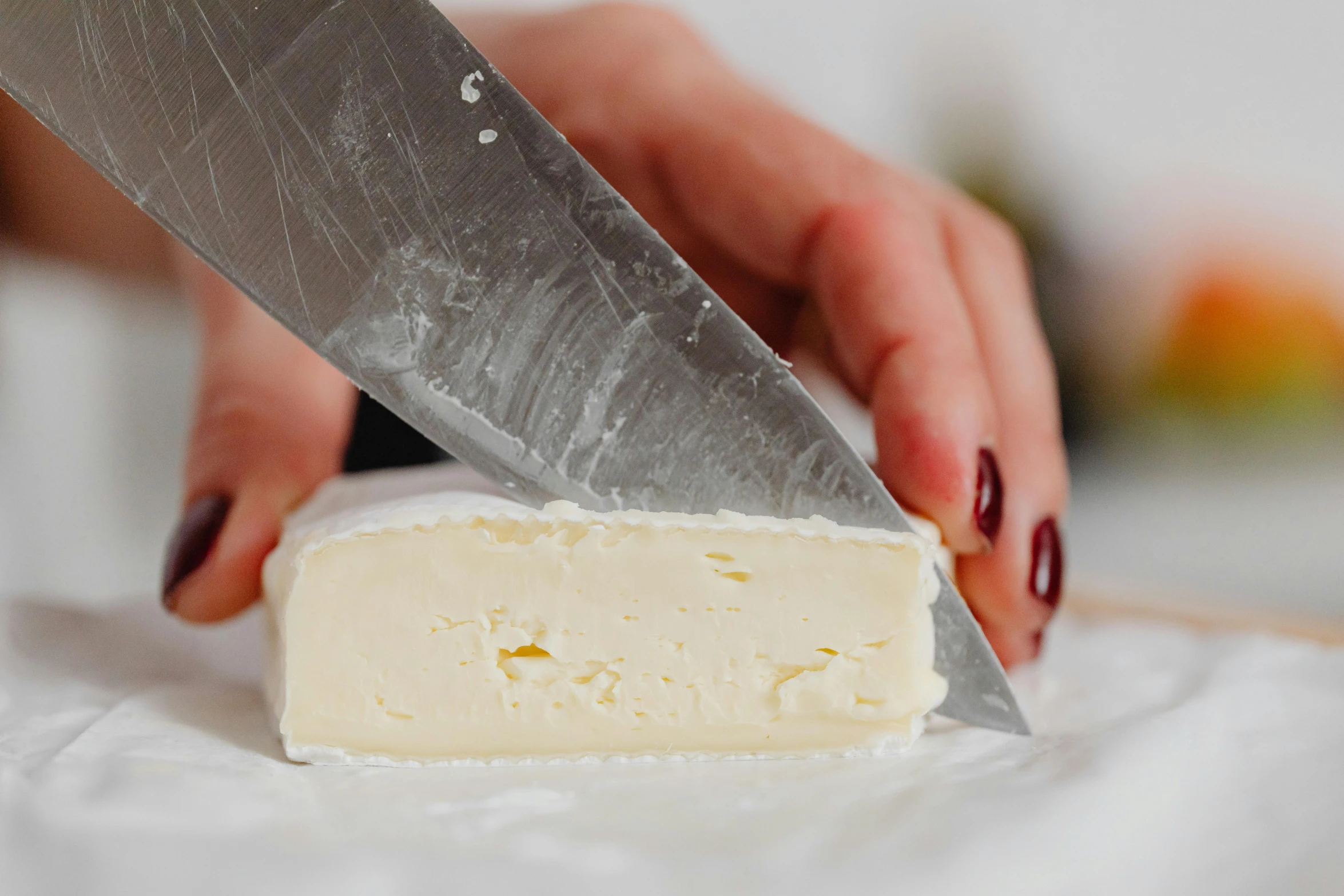 a person cutting a piece of cheese with a knife, by Alice Mason, shiny crisp finish, pointè pose, butter, vanilla