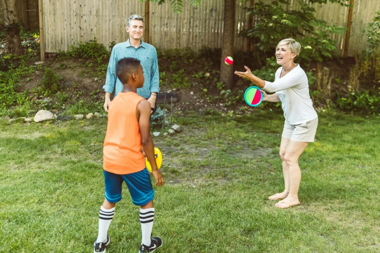 a woman teaching a boy how to throw a frisbee, pexels contest winner, backyard garden, man holding a balloon, multi-part, programming