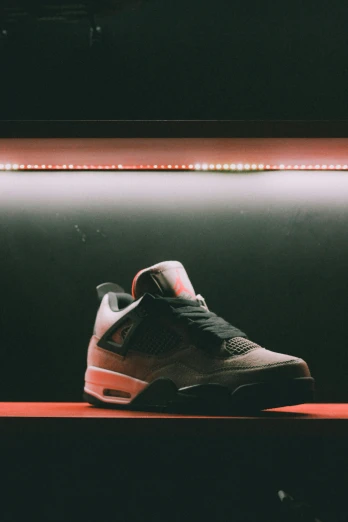 a pair of sneakers sitting on top of a shelf, inspired by Jordan Grimmer, unsplash contest winner, realism, side lights, on display in a museum, vapor, high angle close up shot